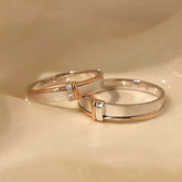 Close-up of minimalist two-tone lab-grown diamond couple rings on hand, modern wedding bands, rose gold and white gold